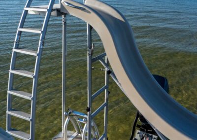 Charter pontoon boat with slide and captain.